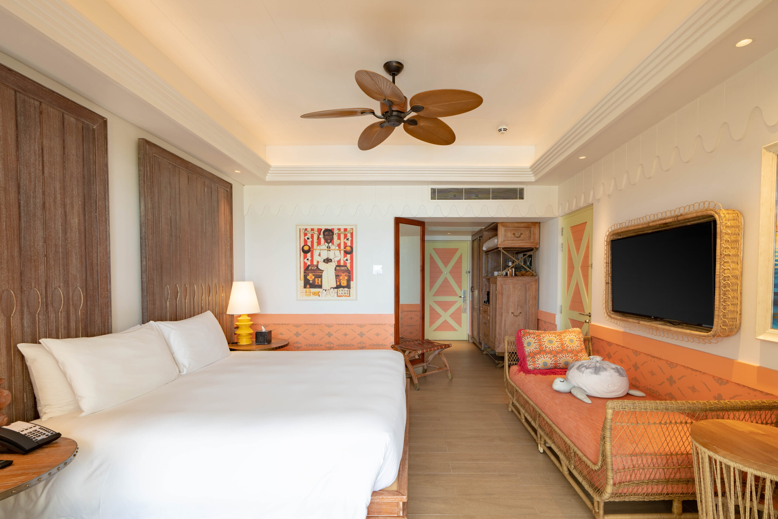 Beach Room with king bed. Room view with TV, sofa and amenities