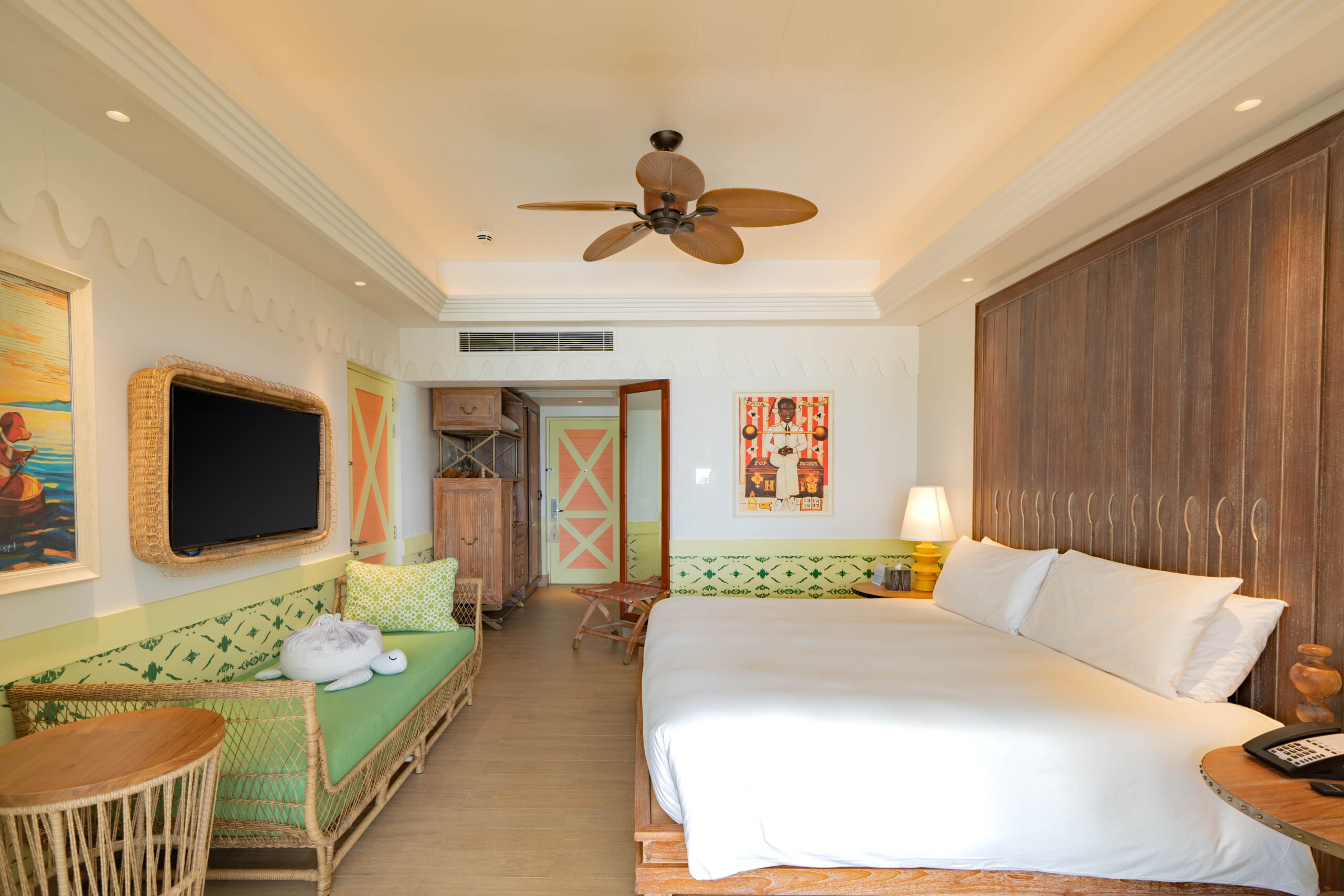 Beach Room with king bed. Room view with TV, sofa and amenities